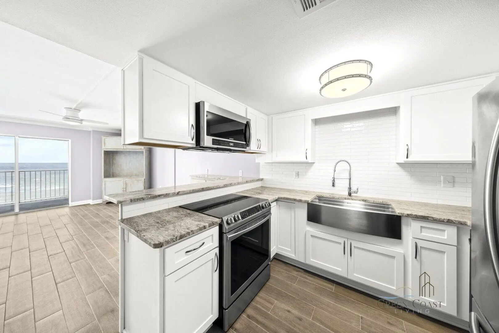 Remodeled condo kitchen with white cabinets and Gulf view in Gulf Shores