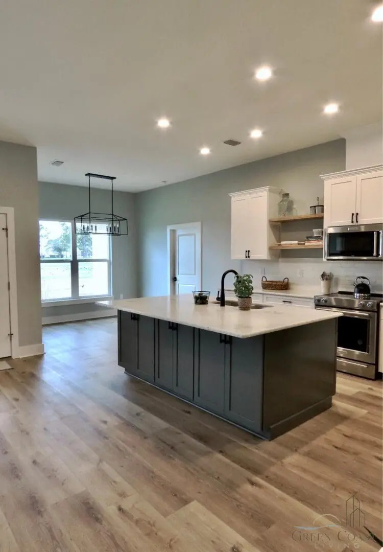 A custom designed kitchen with hardwood floors and a center island.