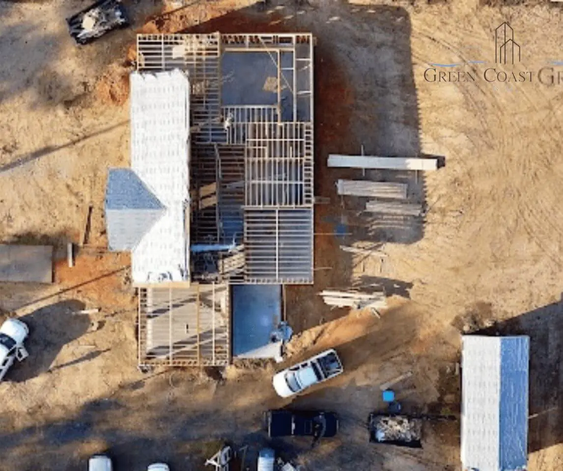 Aerial view of a home addition under construction in Spanish Fort, Alabama, with exposed framing