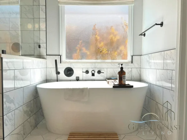 Freestanding bathtub beneath a window in a Daphne bathroom remodel