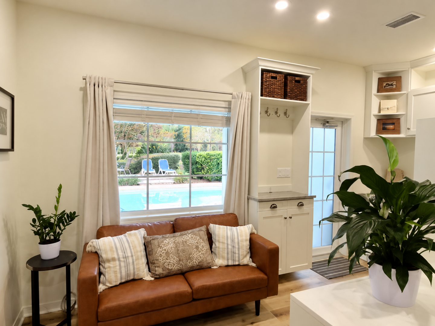 Updated living area in Summerdale with built-in cabinetry, wood flooring, and comfortable seating.